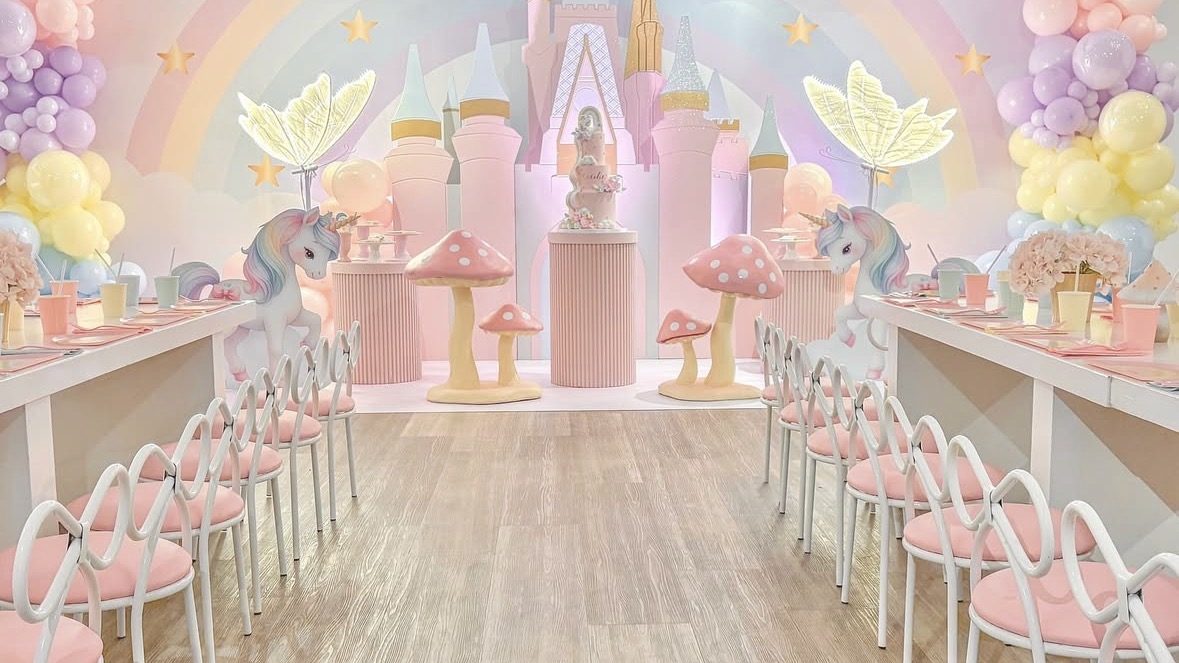 A complete Mini Moments Hire installation: laid table, cross-back chairs and sculptural animal props.